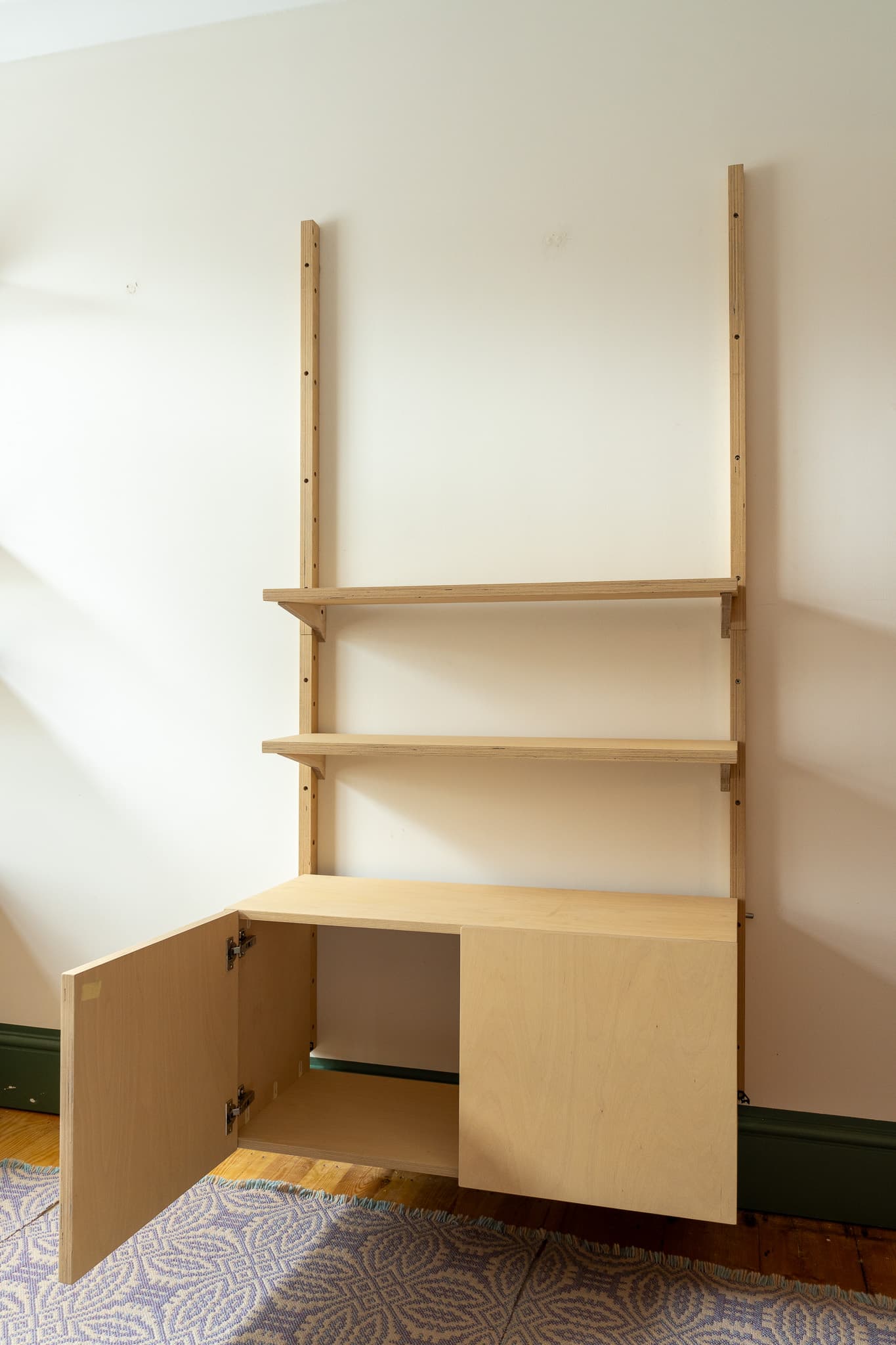 Open MESTRA cupboard module showing birch plywood construction